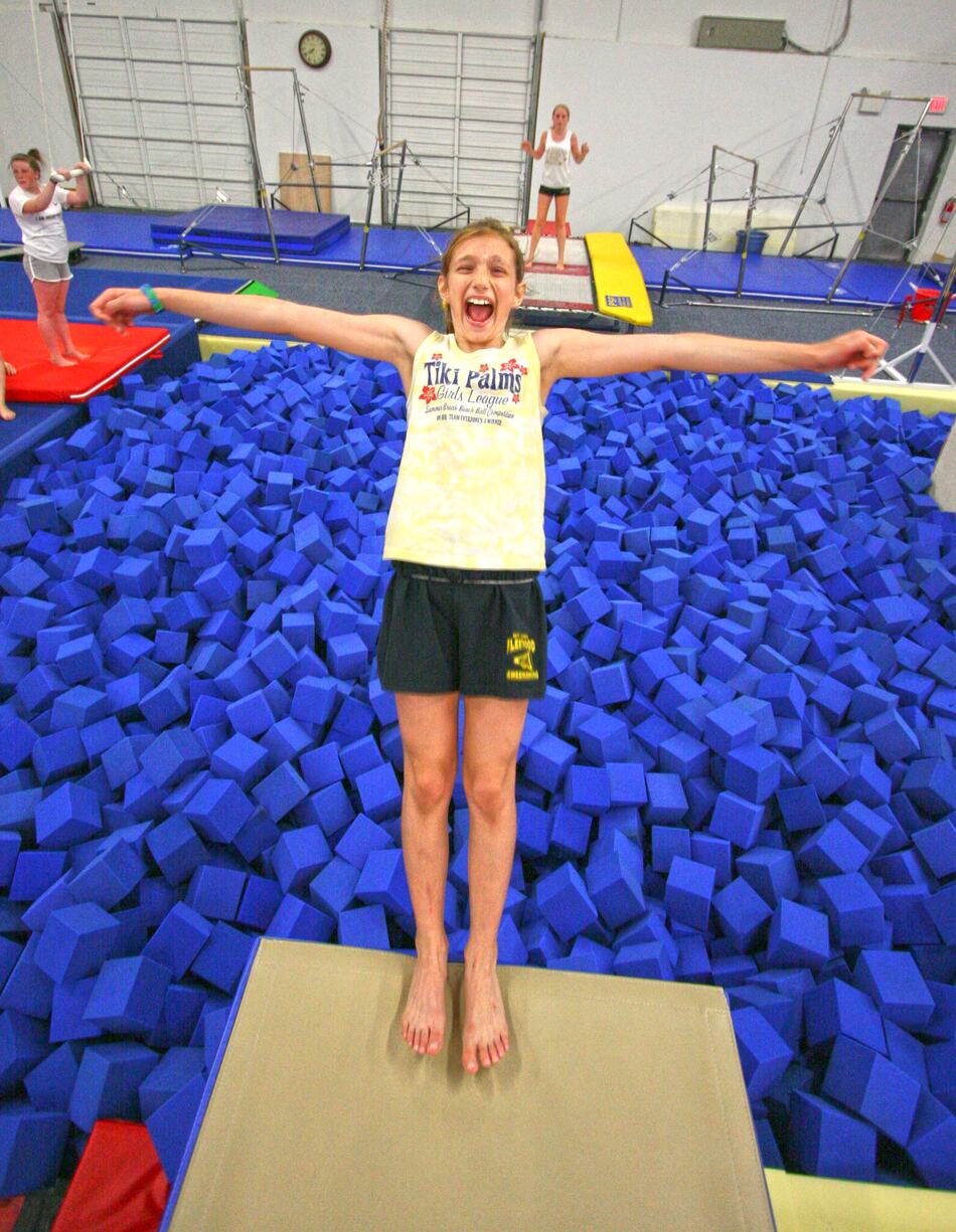 Gymnast leaping into the foam pit
